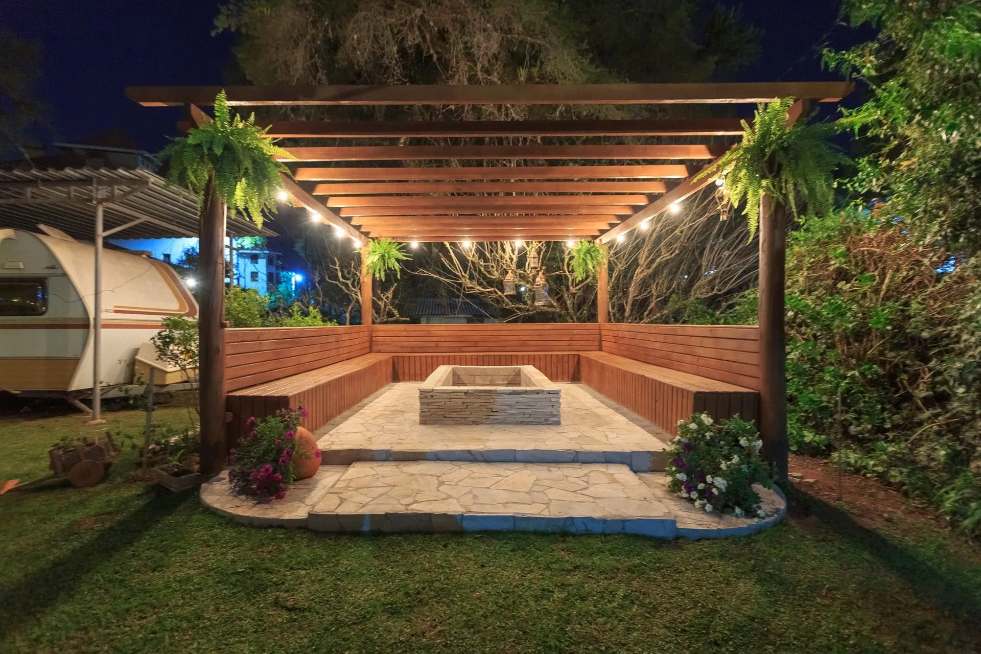 Timber pergola with lights over built-in garden seating, a pergola shade option