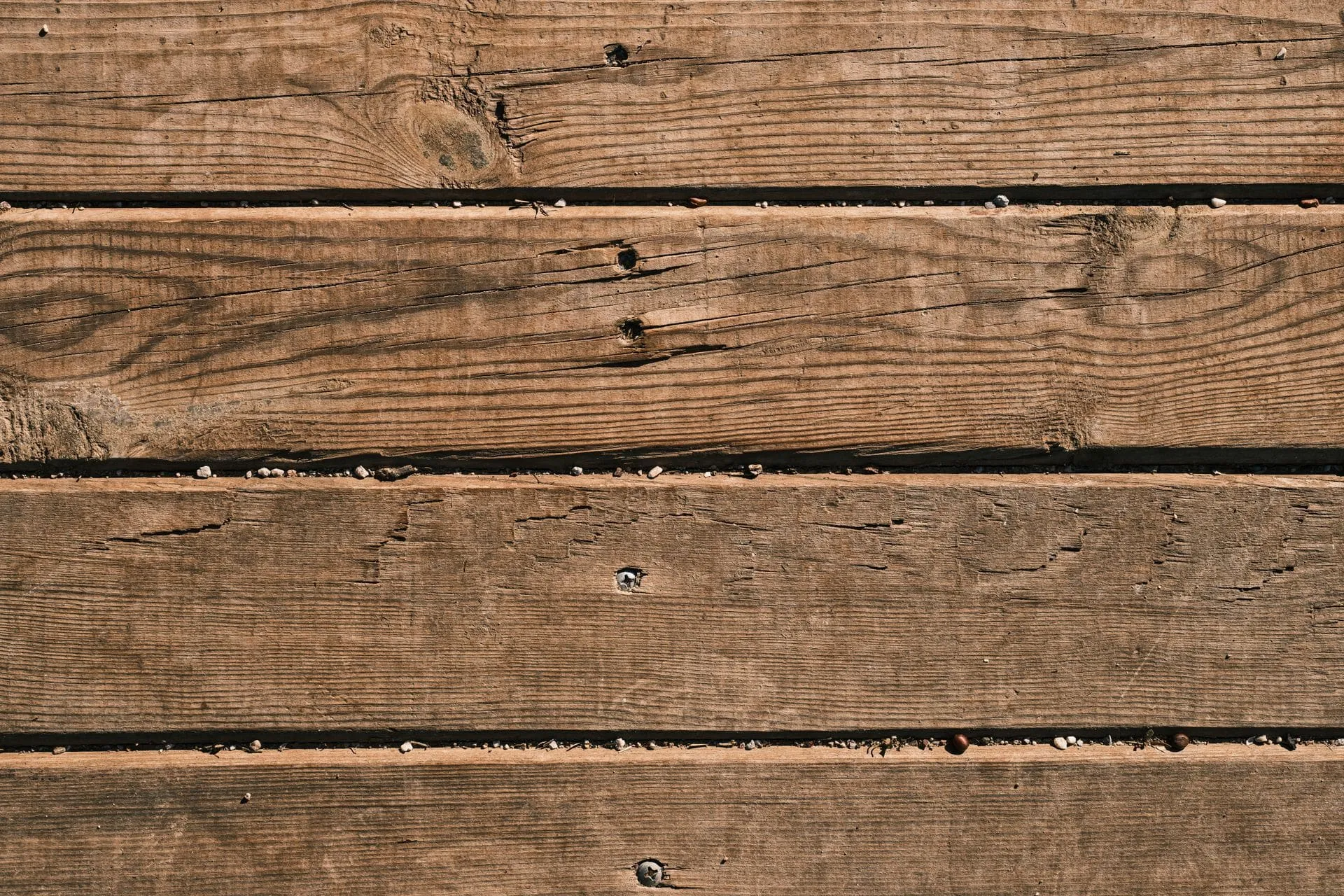 Close-up of brown hardwood decking boards, comparing spotted gum decking and merbau decking